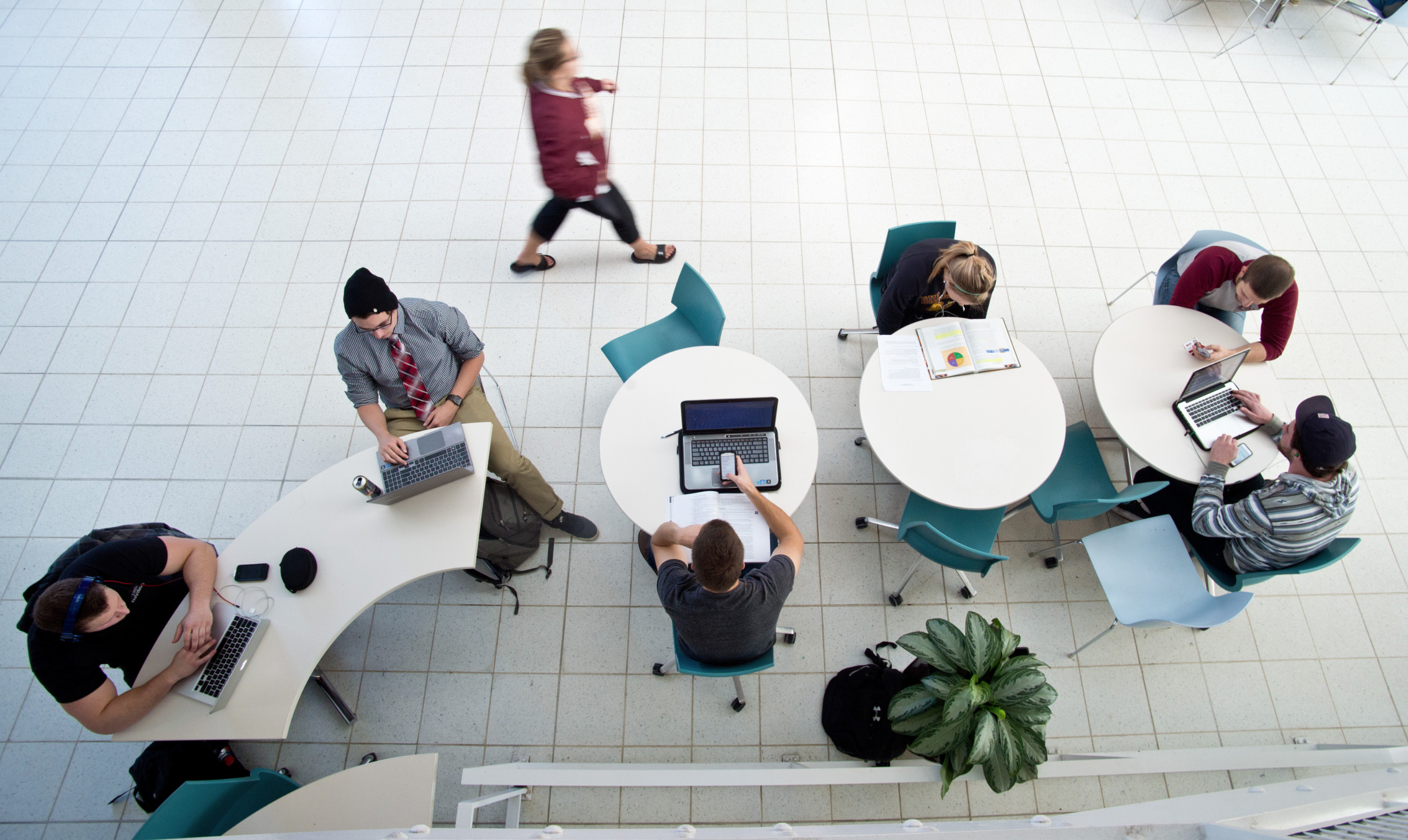 Students studying at tables in LSBE atrium