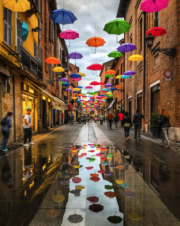 Colorful umbrellas in Italian alley